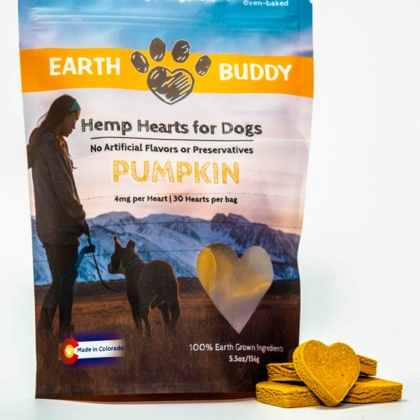 bag of earth buddy pumpkin hemp heart cbd treats for dogs with heart shaped dog treats piled next to bag