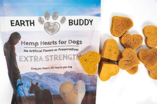 Earth Buddy's Extra Strength best selling cbd treats for dogs with treats laid out.