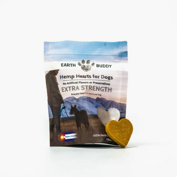 bag of trial size earth buddy extra strength hemp heart cbd treats for dogs with a heart shaped biscuit leaning on bag