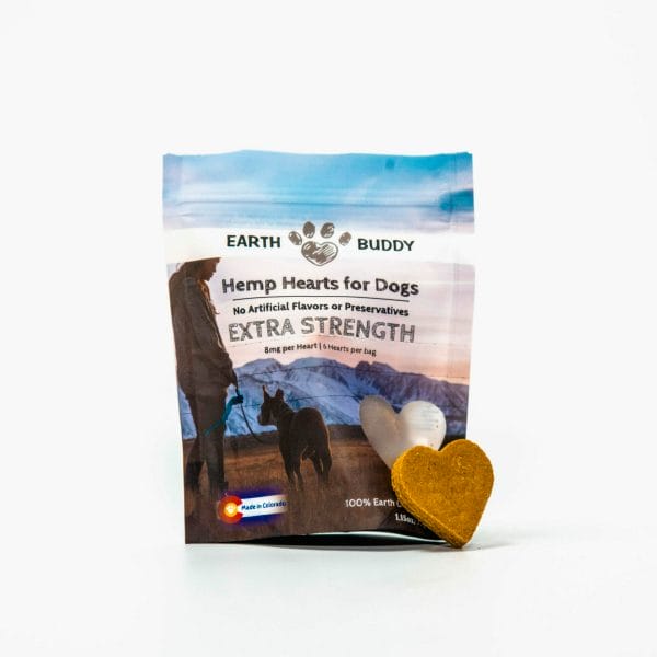 bag of trial size earth buddy extra strength hemp heart cbd treats for dogs with a heart shaped biscuit leaning on bag