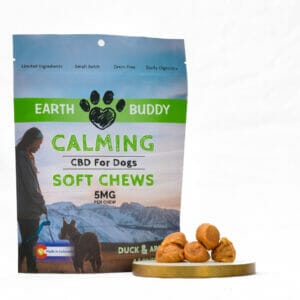 A bag of Earth Buddy small batch Duck & Apple CBD Soft Chews for Small Dogs with cbd treats on coaster.