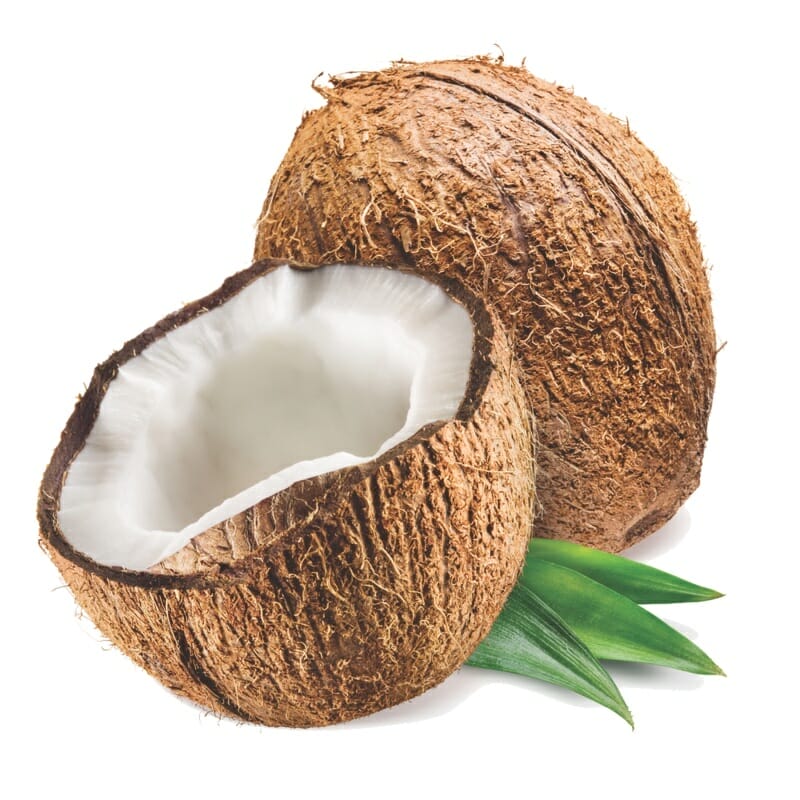 Coconuts displayed cut in half. Coconut oil can help alleviate dry skin in cats.
